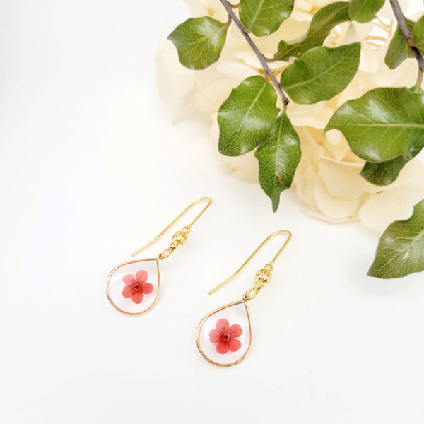 Boucles d'oreilles goutte fleur marguerite teintée rouge résine à plat